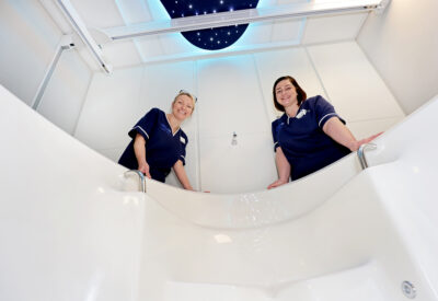 Two midwives looking into a birthing pool